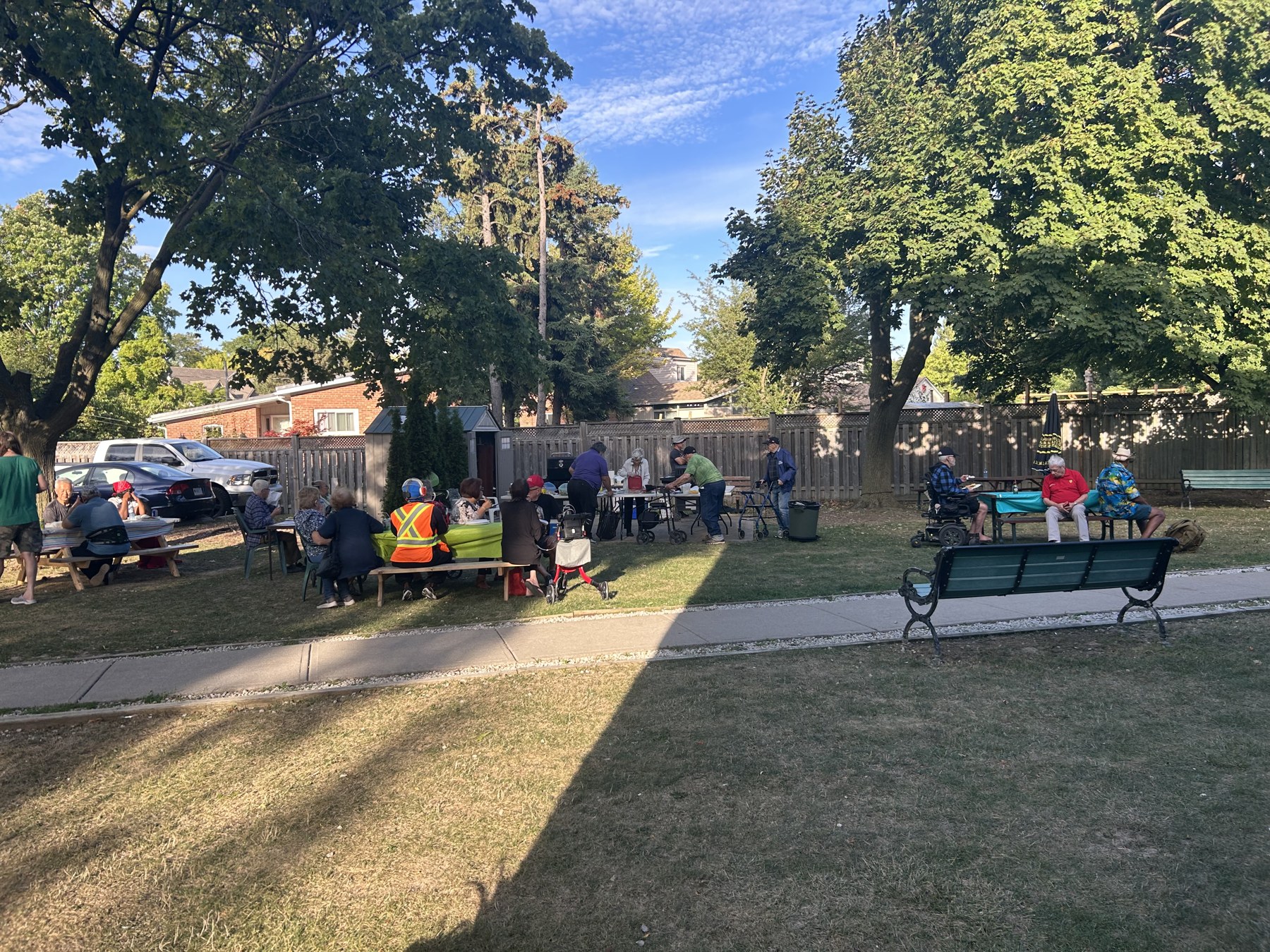 An outdoor community barbecue with veterans and volunteers